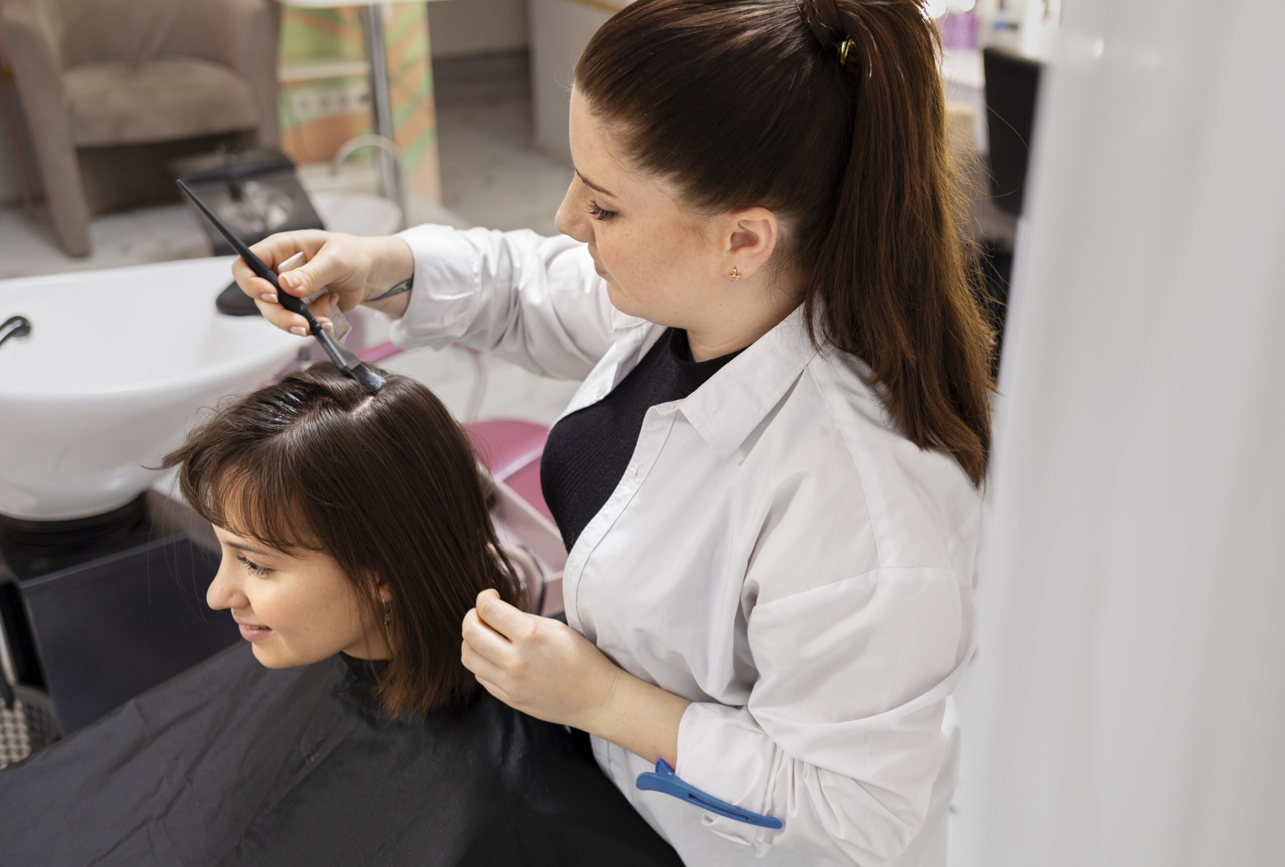 woman getting treatment hairdresser shop